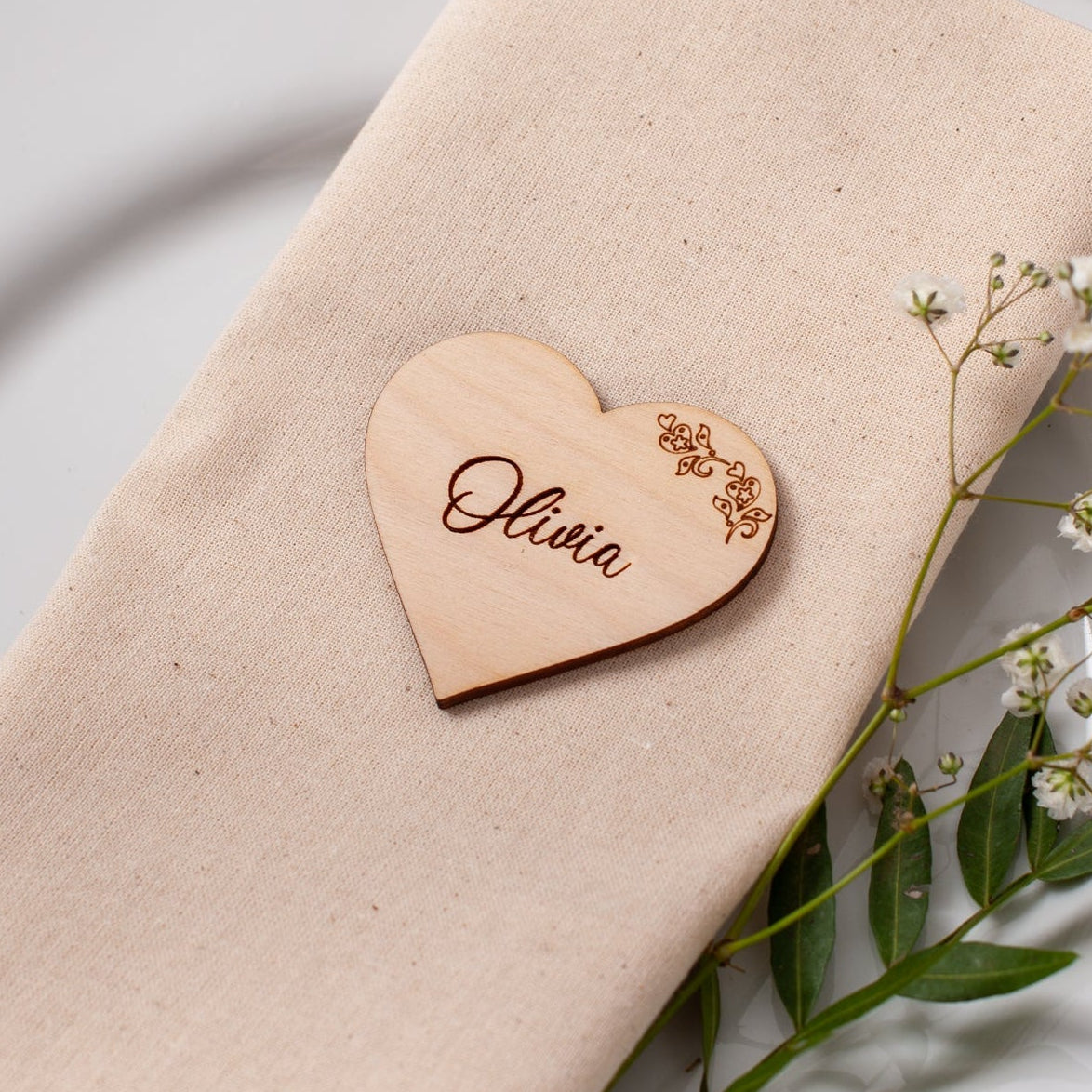 Wooden heart place card with floral cut design for wedding table setting
