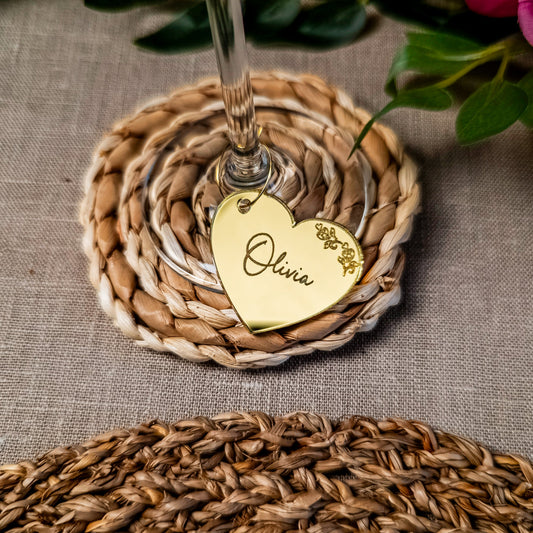 Personalised intricate heart wine charm name tag attached to champagne glass