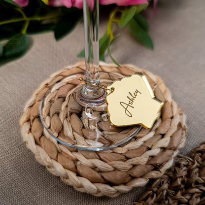 Sea shell wine charm attached to champagne glass with engraved name