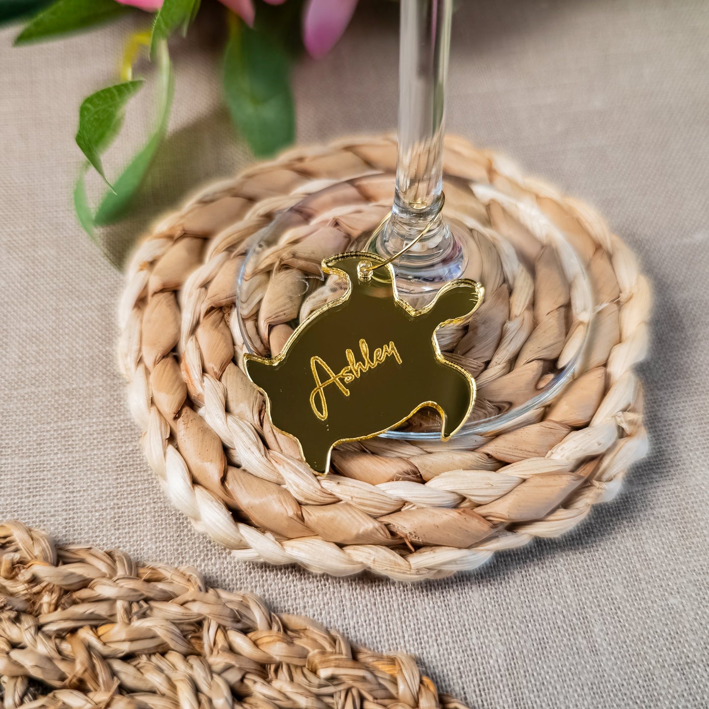 Sea turtle wine charm attached to champagne glass with engraved name