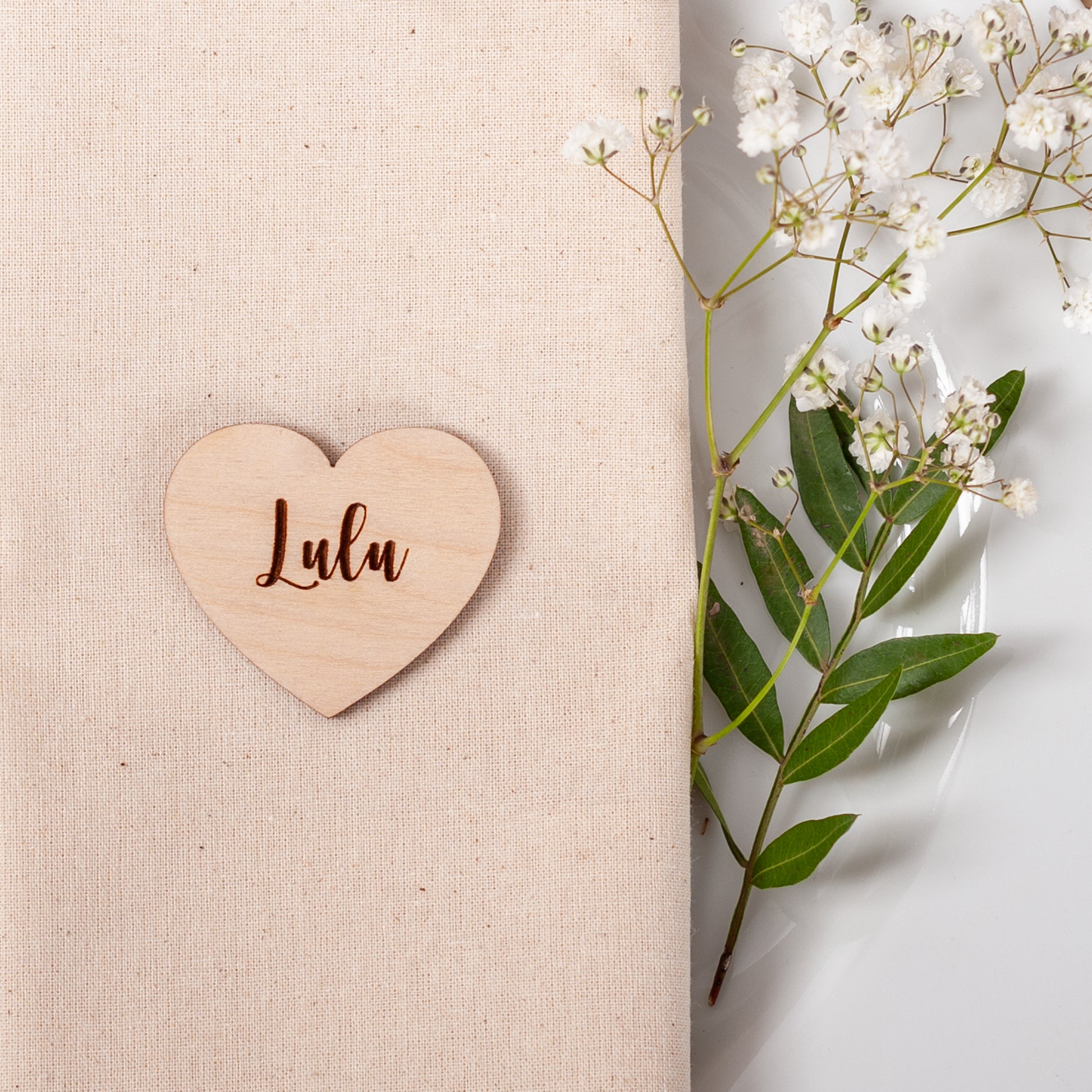Personalised wooden heart place card engraved with guest name for wedding table