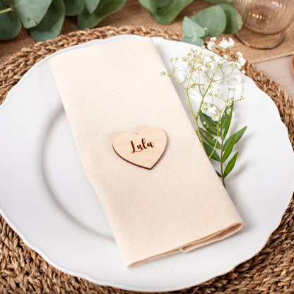 Engraved wood heart place card used for wedding table setting with names