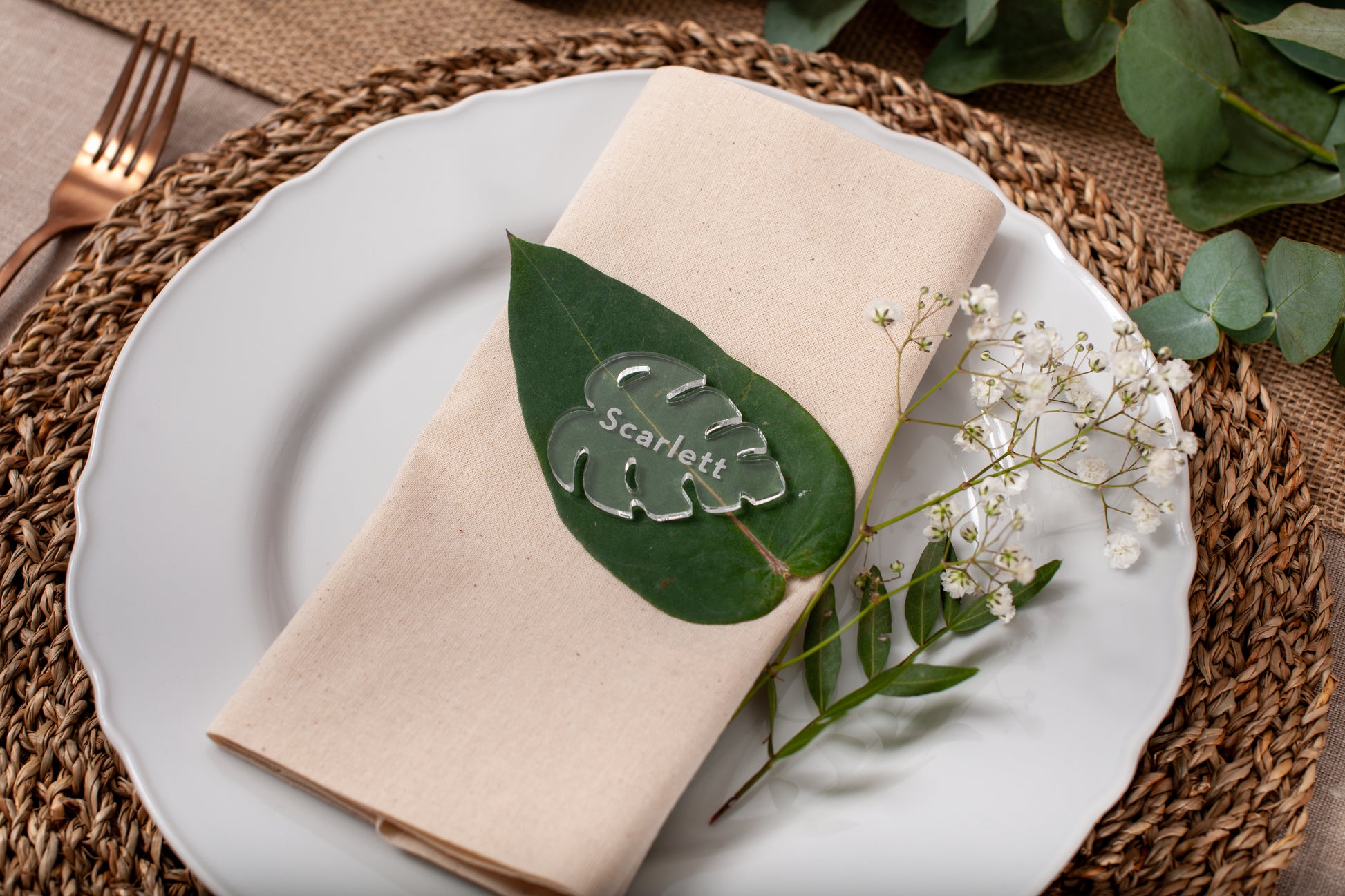 Personalised clear acrylic monstera leaf place card with engraved guest name
