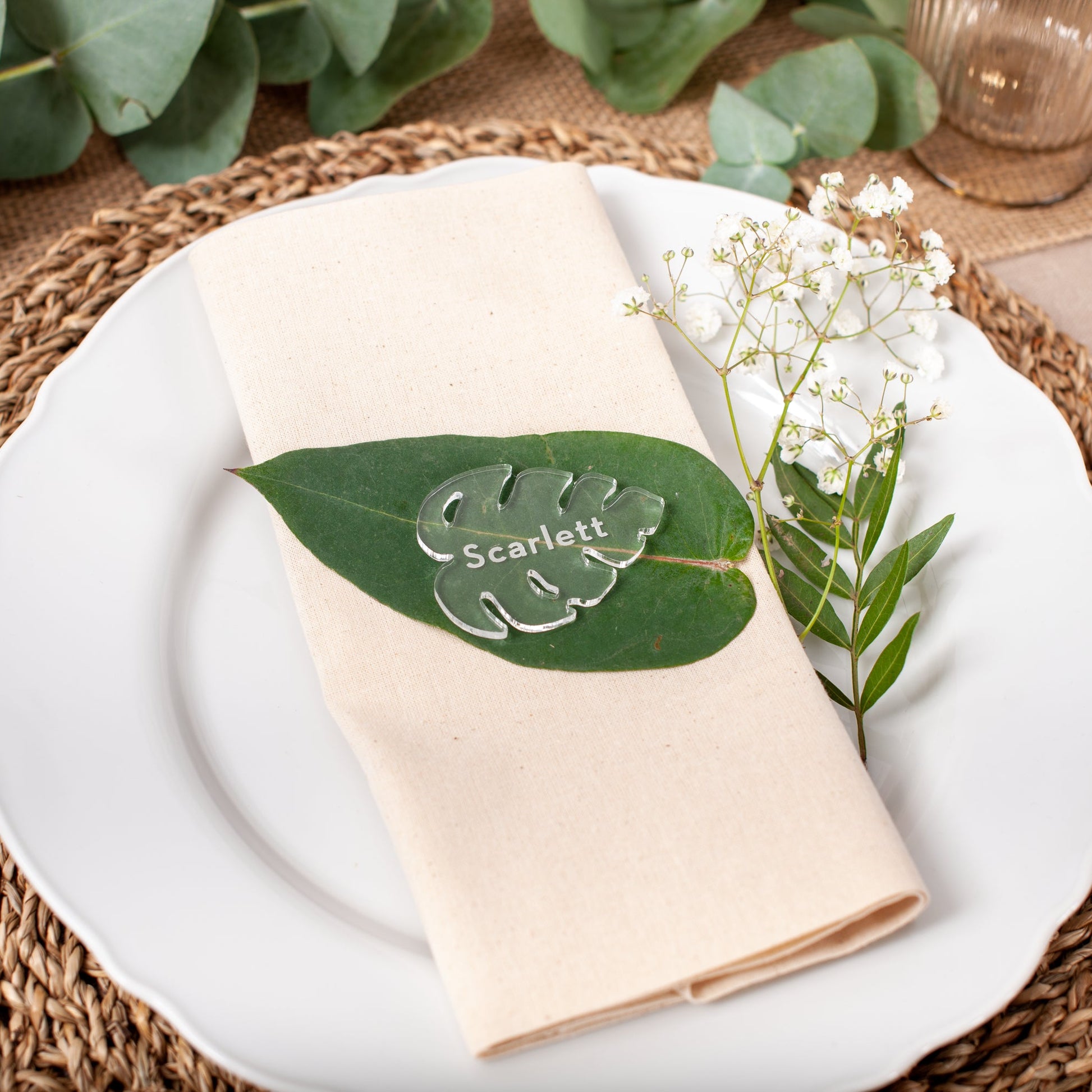 Clear acrylic monstera leaf place card for modern wedding table setting