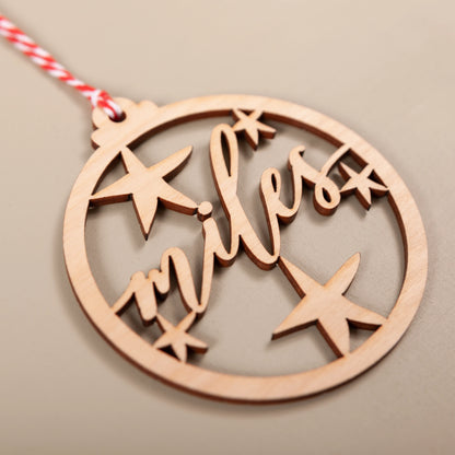 Close-up of custom wooden name bauble showing stars and name