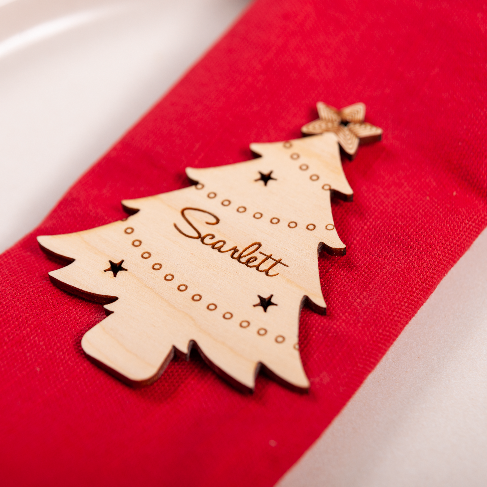 Wooden engraved Christmas tree ornament used as festive place setting