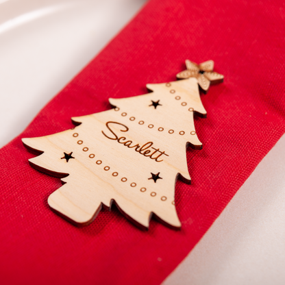 Wooden engraved Christmas tree ornament used as festive place setting