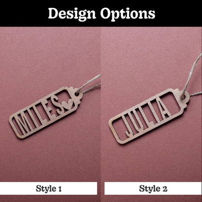 Two wooden name tags, 'MILES' and 'JULIA', on a pink background with 'Design Options' text.