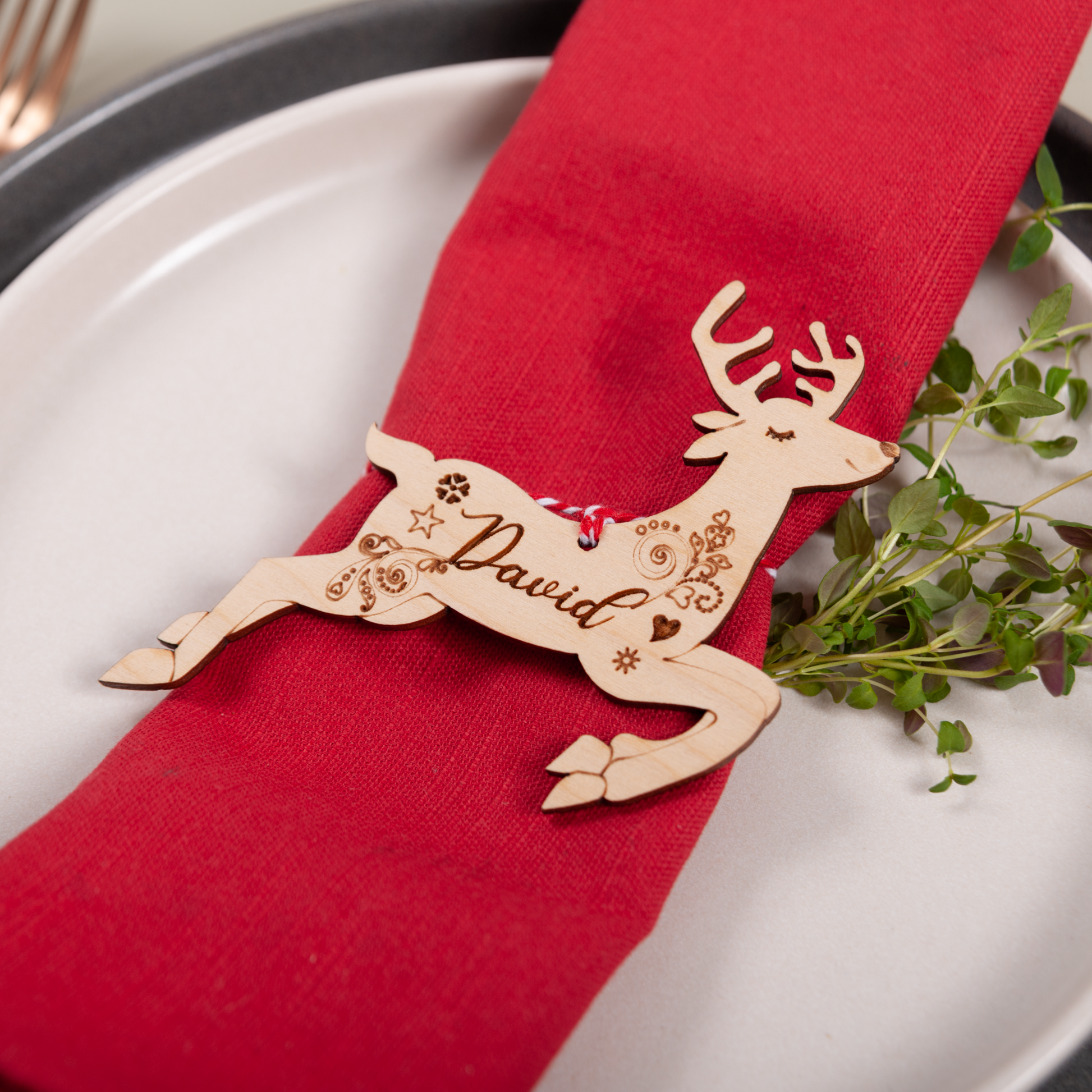 Wooden personalised reindeer name ornament used as table place setting